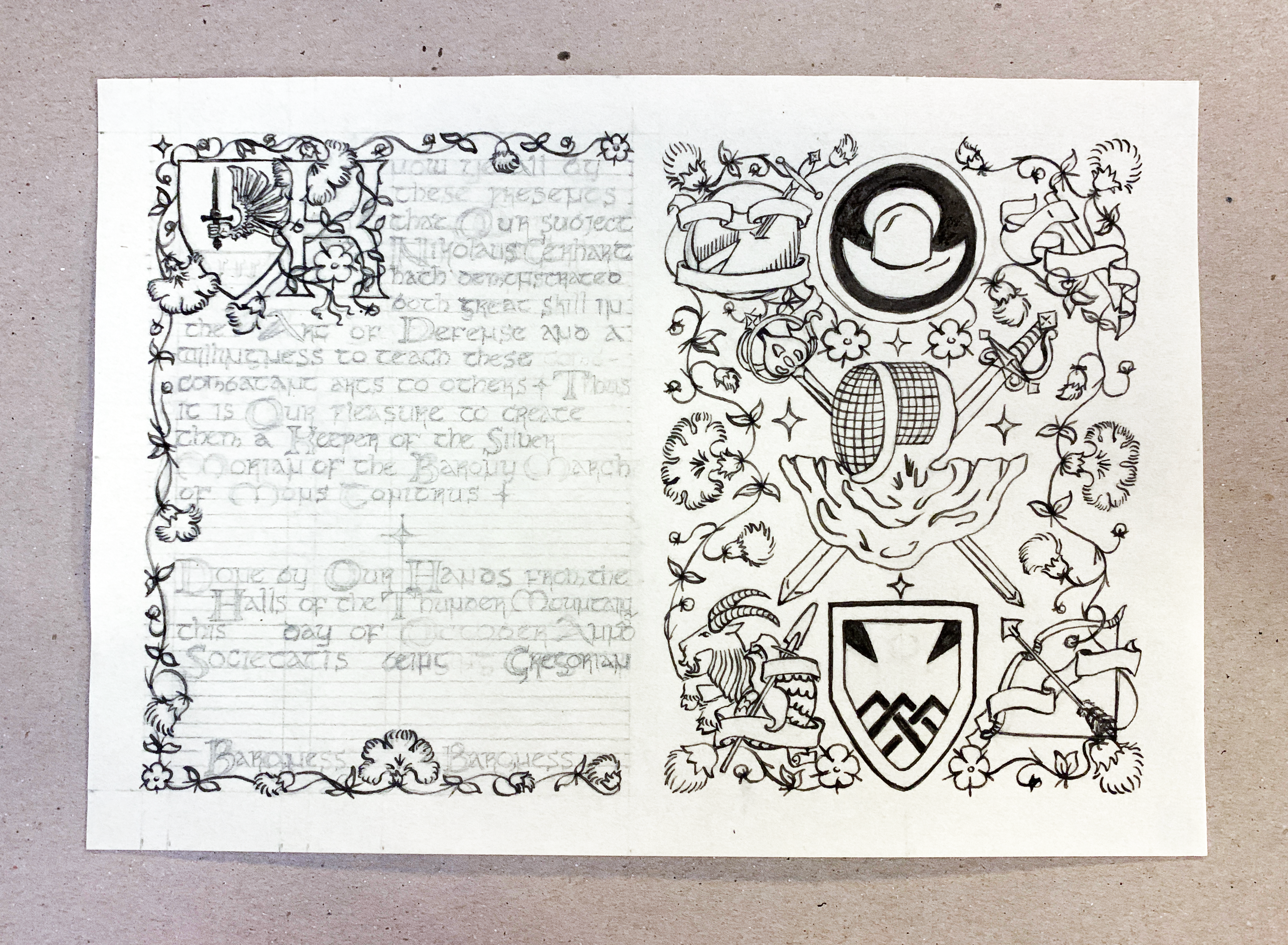 A medieval scroll award in progress: the ink stage, with ink work finished on the right side, and the floral border, decorated K, and shield device inked on the left