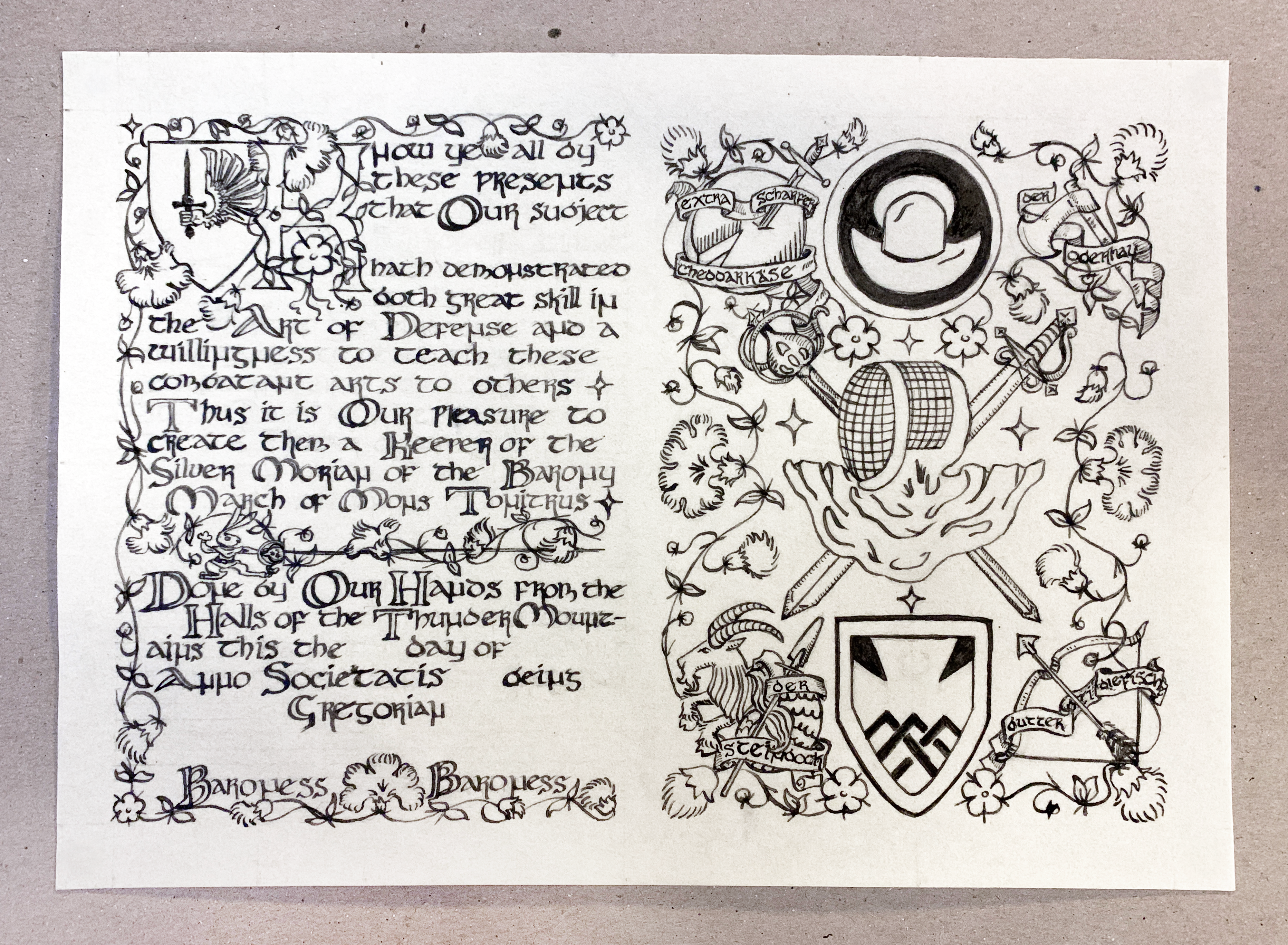 A medieval scroll award in progress: the ink stage, all inkwork finished, including full calligraphy in uncial inspired hand at the left, with added artwork between some lines of text