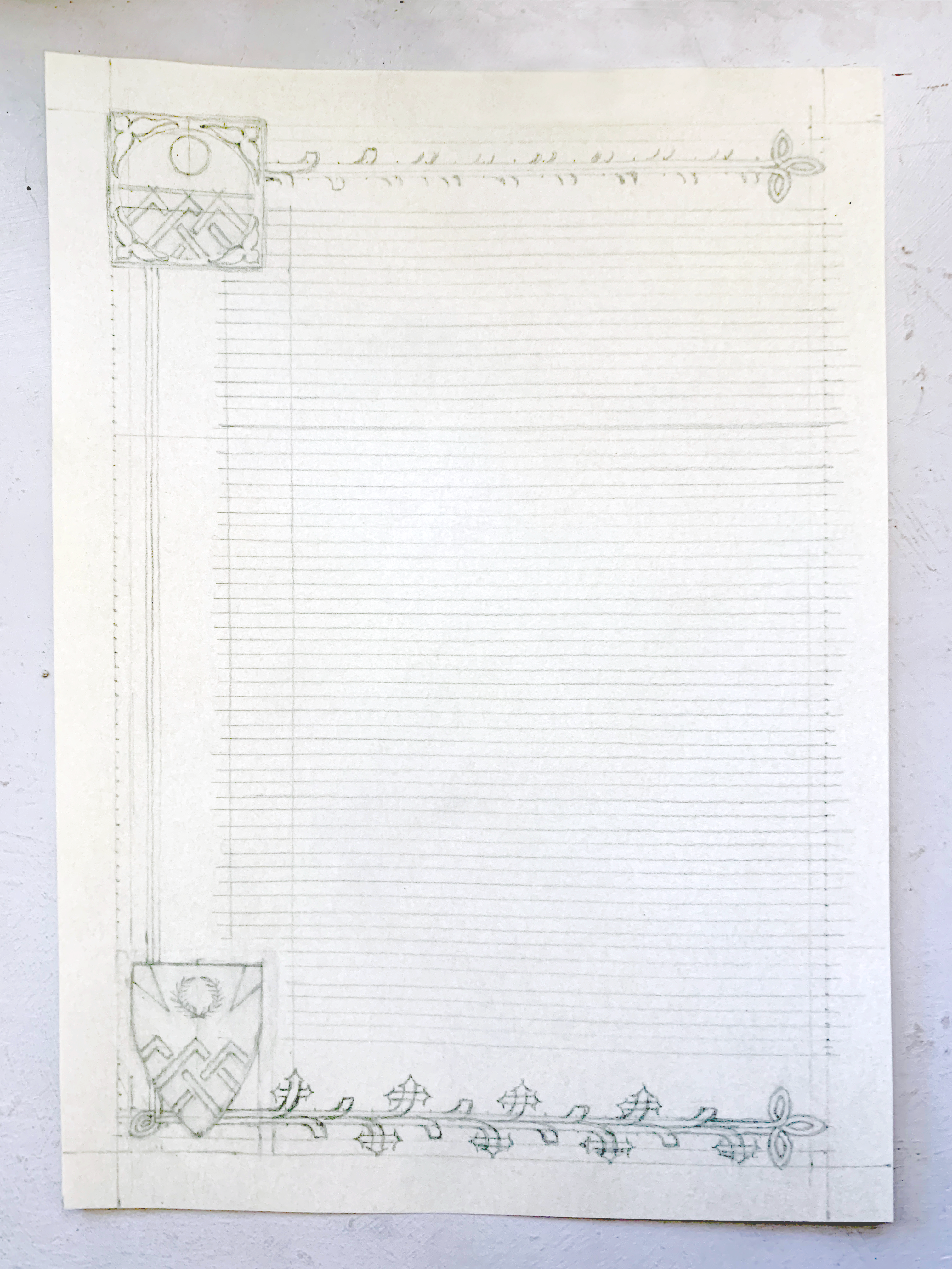 A medieval scroll award in progress: the pencil stage, shield devices and border floral work drawn