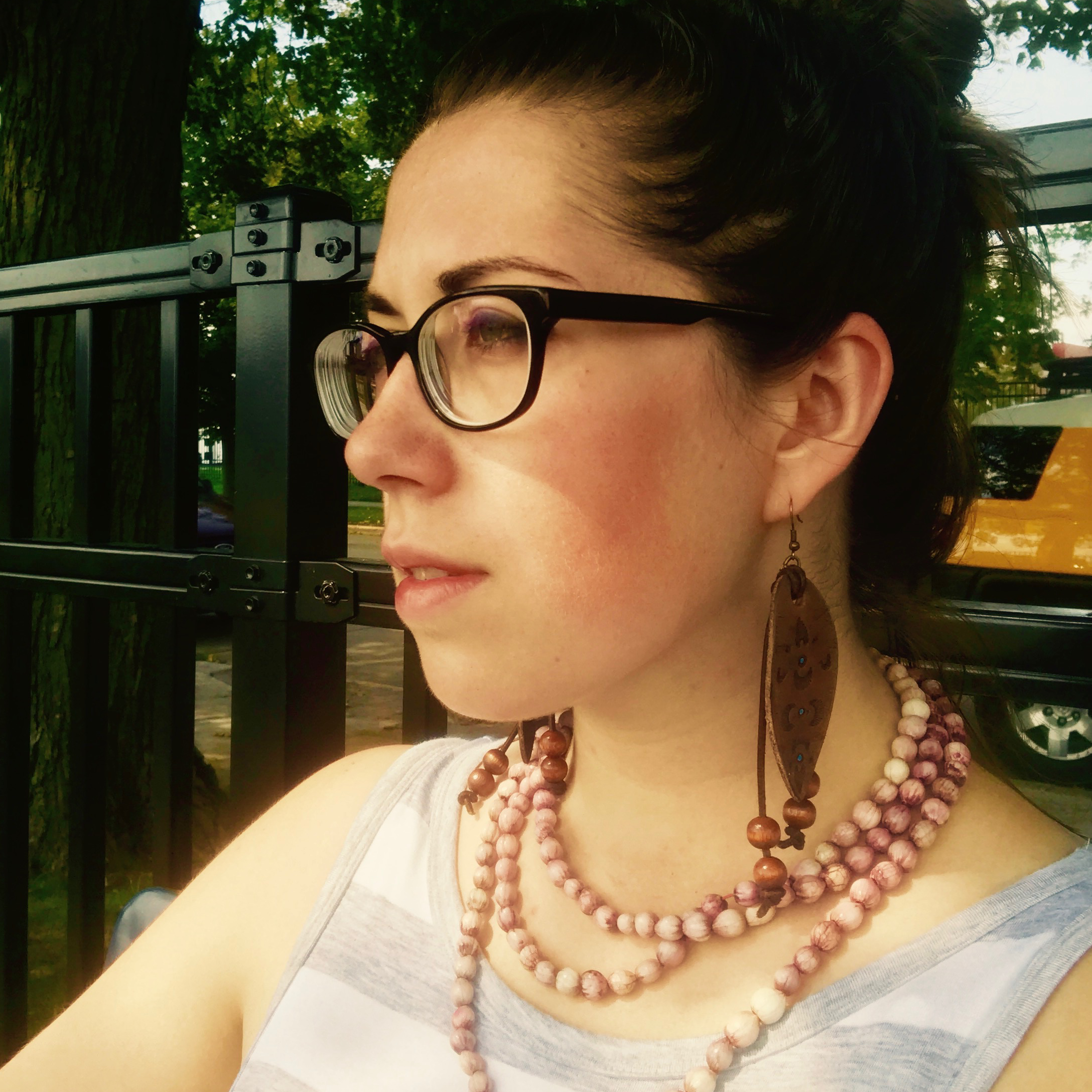 image of the page owner, a girl's face with brown hair and glasses, 
							dressed for summer, looking towards the left side of the frame